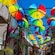 A system of frames support rainbow colored umbrellas and bougan villa plants above an alleyway in Puerto Plata’s Old Town